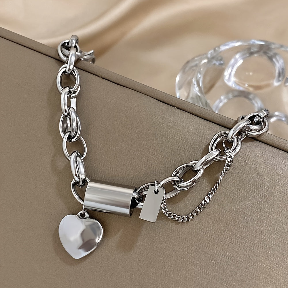 Fashionable heart pendant wrist jewelry made of thick gold-colored stainless steel chain with a punk and chunky design.