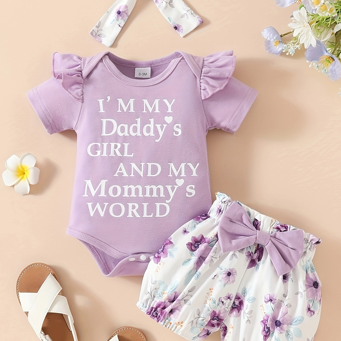 Cute 3-piece girls' outfit set with 'Daddy's Girl, Mommy's World' letter print romper, floral shorts, and matching headband. Made of soft polyester blend, ideal for summer and outdoor wear.