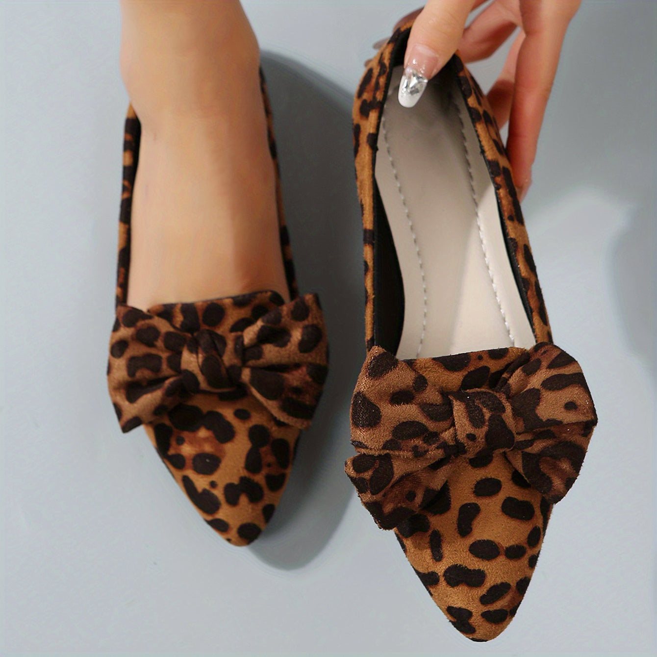 Leopard print flat shoes with bowknot decor and point toe, lightweight slip on style.