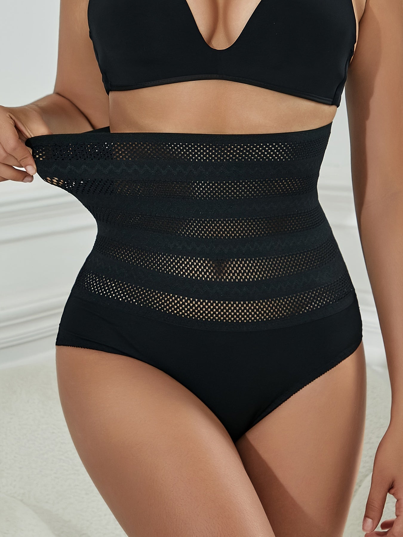 Lace panty with tummy control and butt lifting features for women.