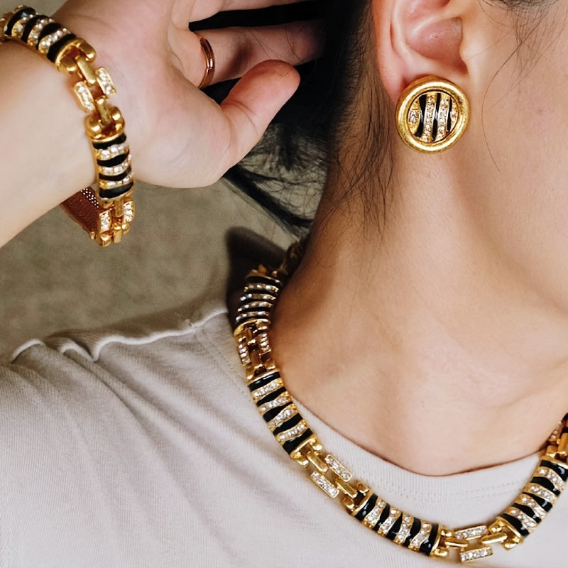 Chic and Stylish French-Inspired Zebra Print Jewelry Set - Featuring Vintage Geometric Design in Gold Plated Enamel with Sparkling Rhinestone Details. Complete with Necklace, Bracelet, and Earrings; Ideal for Everyday Wear, Events, and Celebrations.