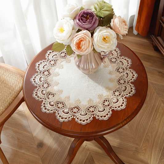 Elegant round lace placemat in various sizes. Made of polyester with embroidered water-soluble lace. Machine washable and heat resistant. Suitable for home decor, parties, and weddings.