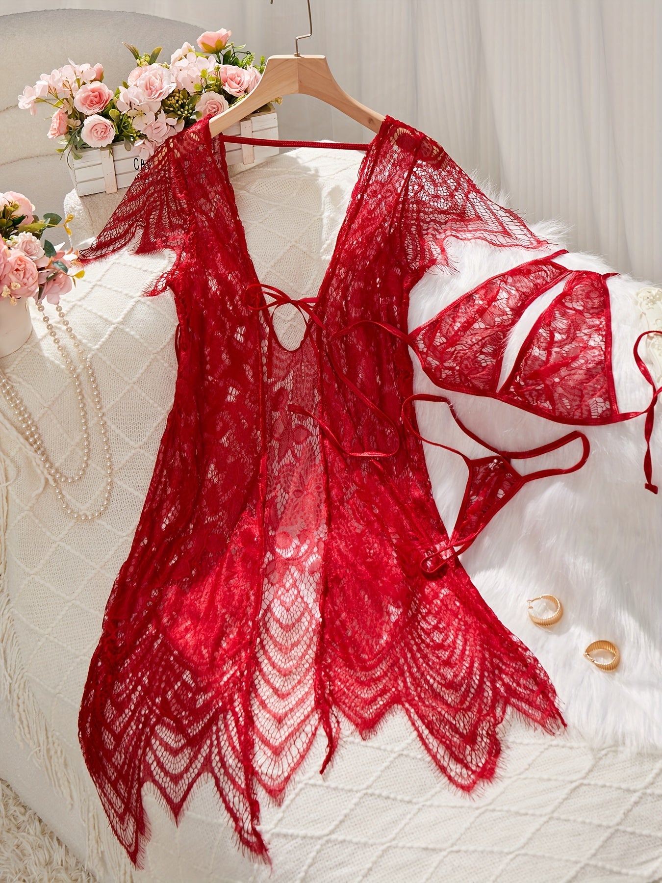 Lace lingerie set with belt and cardigan, bra, and thong for women.