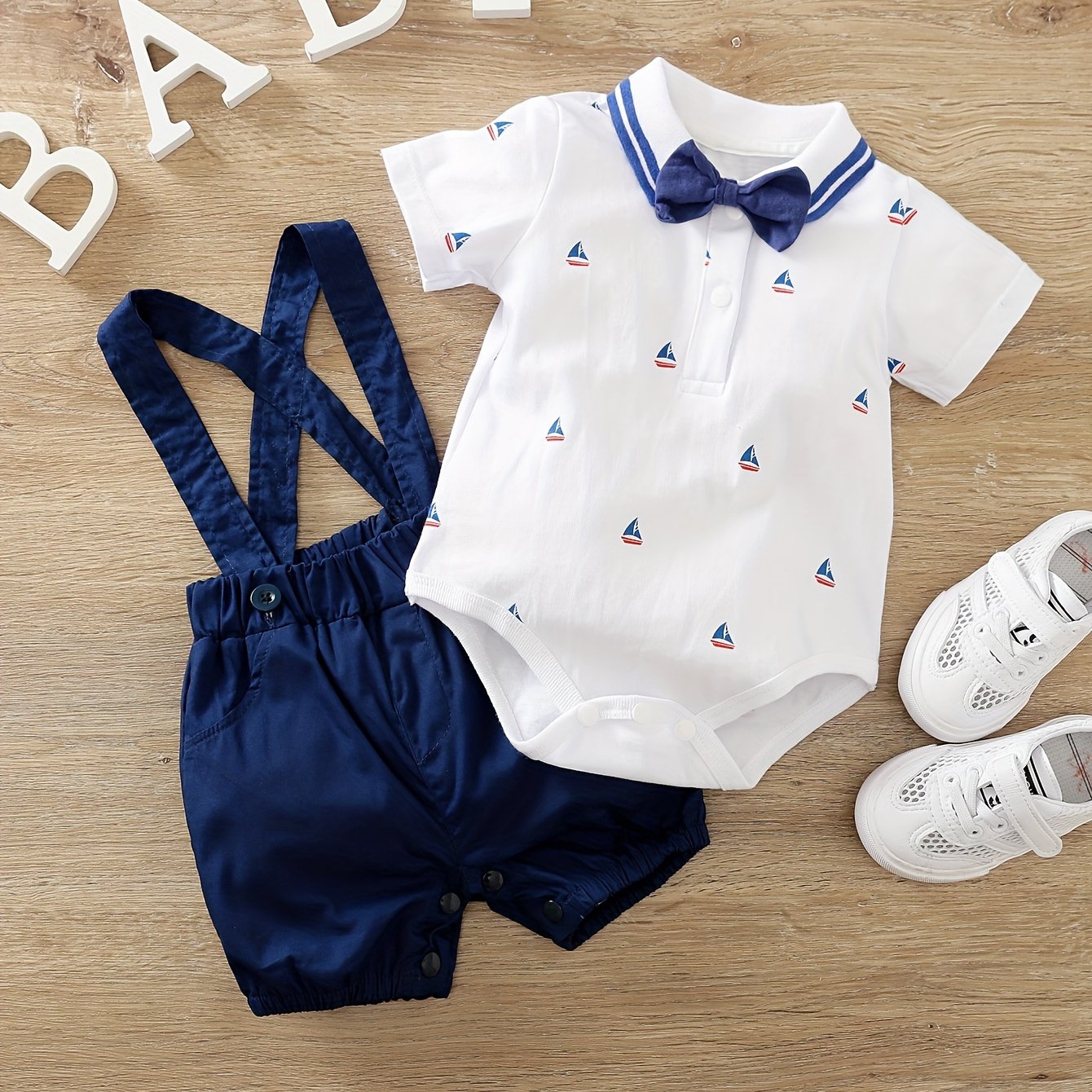 Newborn cotton romper with suspenders for outdoor wear.