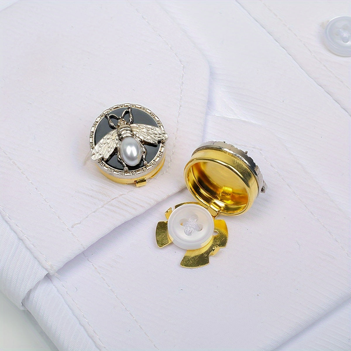 Get a pair of elegant Golden Bee cufflinks and shirt buttons set for a fashionable and seamless look. Made of shiny copper, these clip-on buttons are perfect for formal tailcoat attire and add a touch of luxurious decoration to your clothing. This fancy