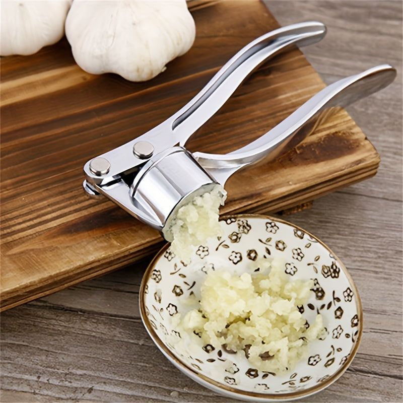 Handheld metal garlic press for manually crushing garlic and ginger in the kitchen.Ideal for kitchen accessories.