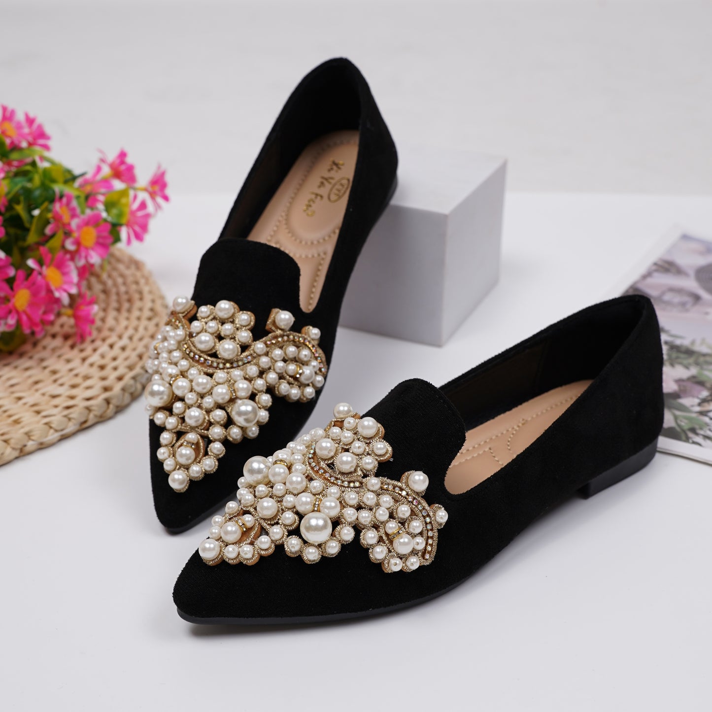 Women's elegant flat shoes with faux pearl decoration, point toe design, and lightweight comfort.