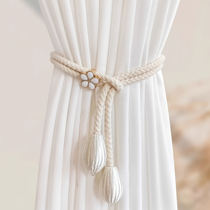 Two pieces of stylish adjustable curtain tiebacks with a modern floral buckle design and pearl accent. Made from polyester rope, these holders are perfect for adding an elegant touch to your window decor.