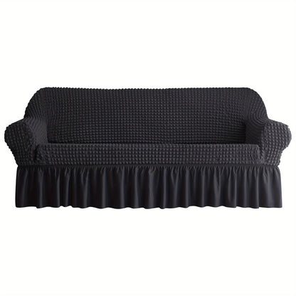 Non-slip elastic sofa cover with skirt for home decor.