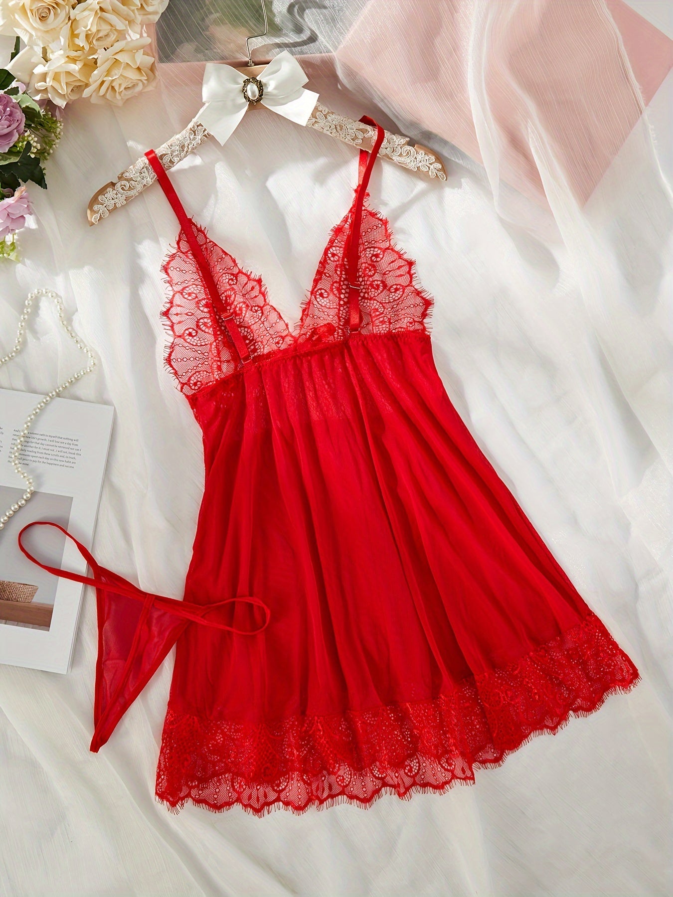 Sexy red lingerie set with lace and bow details, includes dress and thong. Perfect for women.