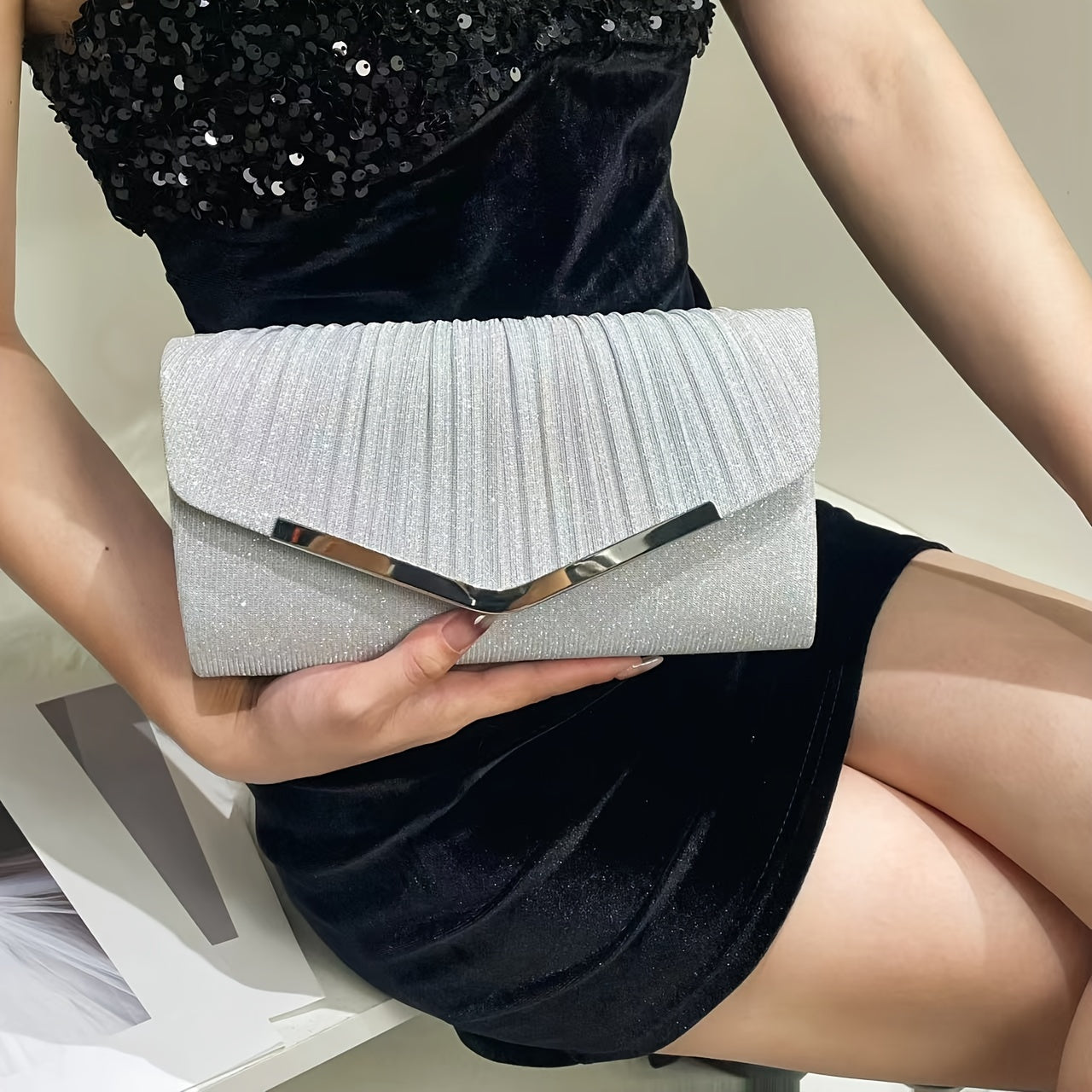 A dazzling envelope clutch adorned with gold accents, ideal for chic women at weddings and parties.