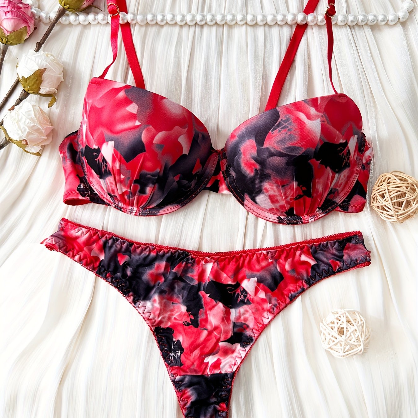 Red and black floral print push-up bra and thong set for women made of comfortable nylon blend. Ideal for casual attire.