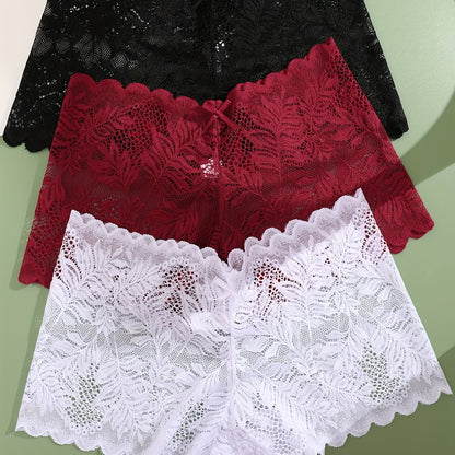 Set of three low-rise lace boyshort panties by FINETOO in black, white, and pinkish-beige floral patterns. Crafted from a breathable, stretchy nylon blend with scalloped trim.