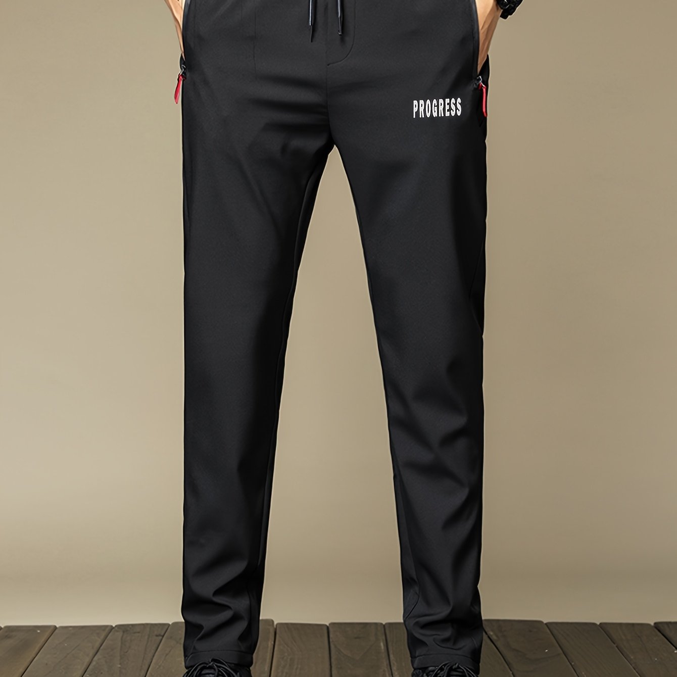 Men's casual long pants made from 100% polyester with a print design. Designed for comfort with breathable and quick-dry fabric. Features zipper pockets and a regular fit. Suitable for