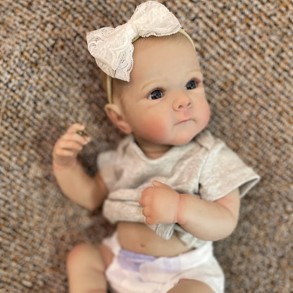 20" lifelike waterproof vinyl reborn girl doll with realistic 3D painted skin and hand-painted hair. Bathable and comes in a comfy gray outfit with headband. Perfect for girls.