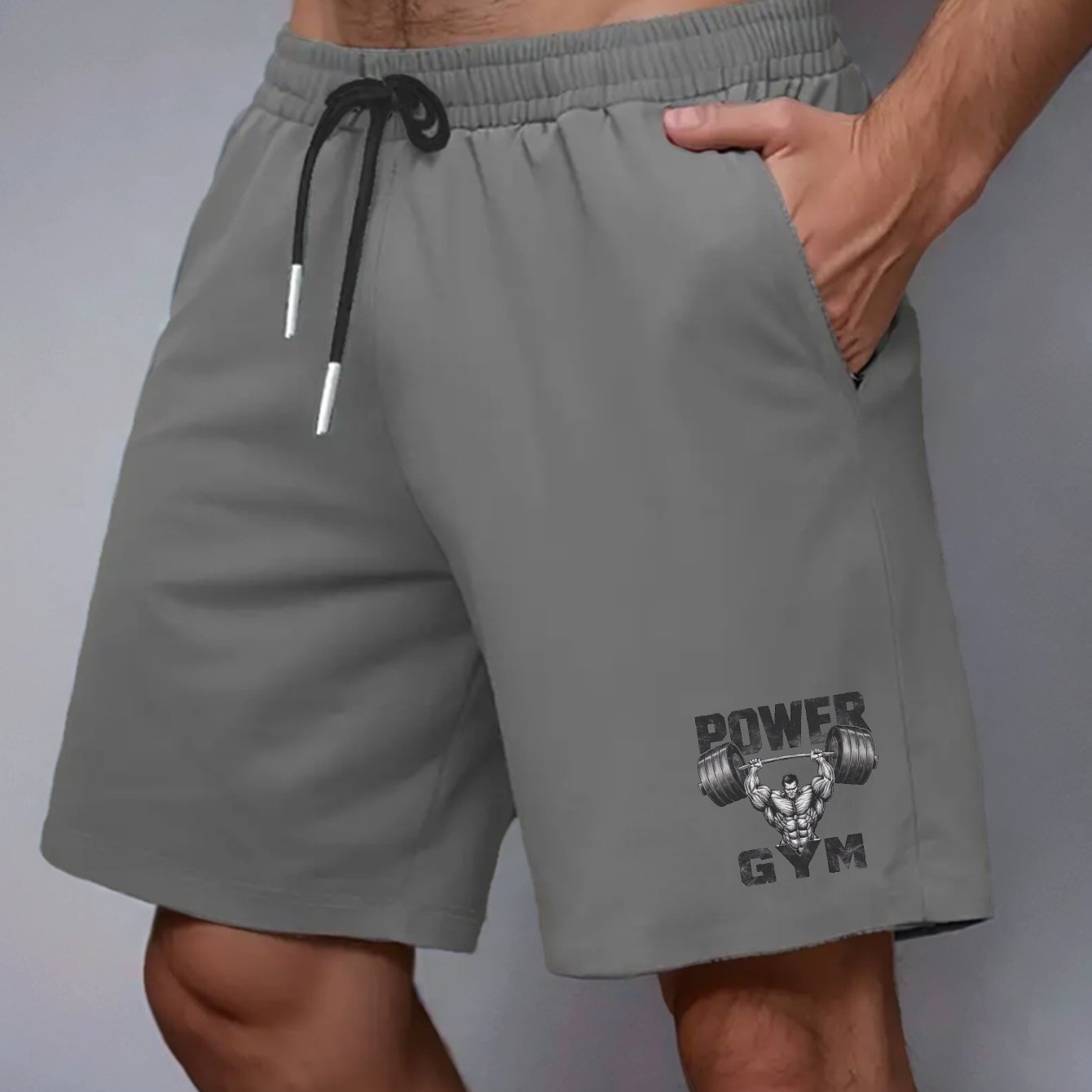 Power Gym Men's casual shorts made of 100% polyester non-stretch woven fabric. Features regular fit with pockets and a muscular barbell print. Big and tall sizes, plus sizes available.