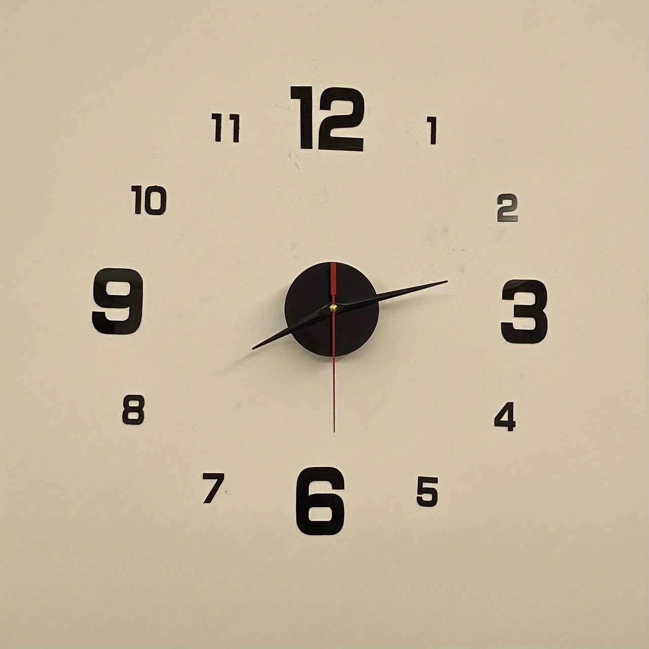 Modern minimalist wall clock with large black numbers, acrylic mirror design for living room or bedroom. Self-adhesive, battery operated (AA not included), 40x40cm.