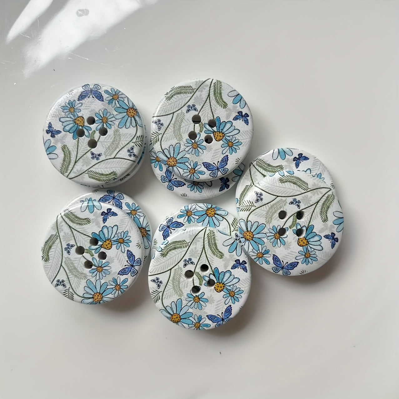 A set of 10 large decorative flower and butterfly buttons made of natural wood, each measuring 30mm in size and featuring 4 holes for sewing.