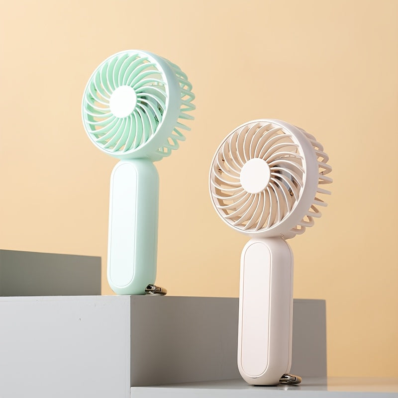 This mini portable fan is perfect for those on the go. It is handheld, personal, USB rechargeable, and battery-operated. You can bring it to the office, bedroom, outdoor travel, and camping. It also comes with a hook loop for easy carrying and