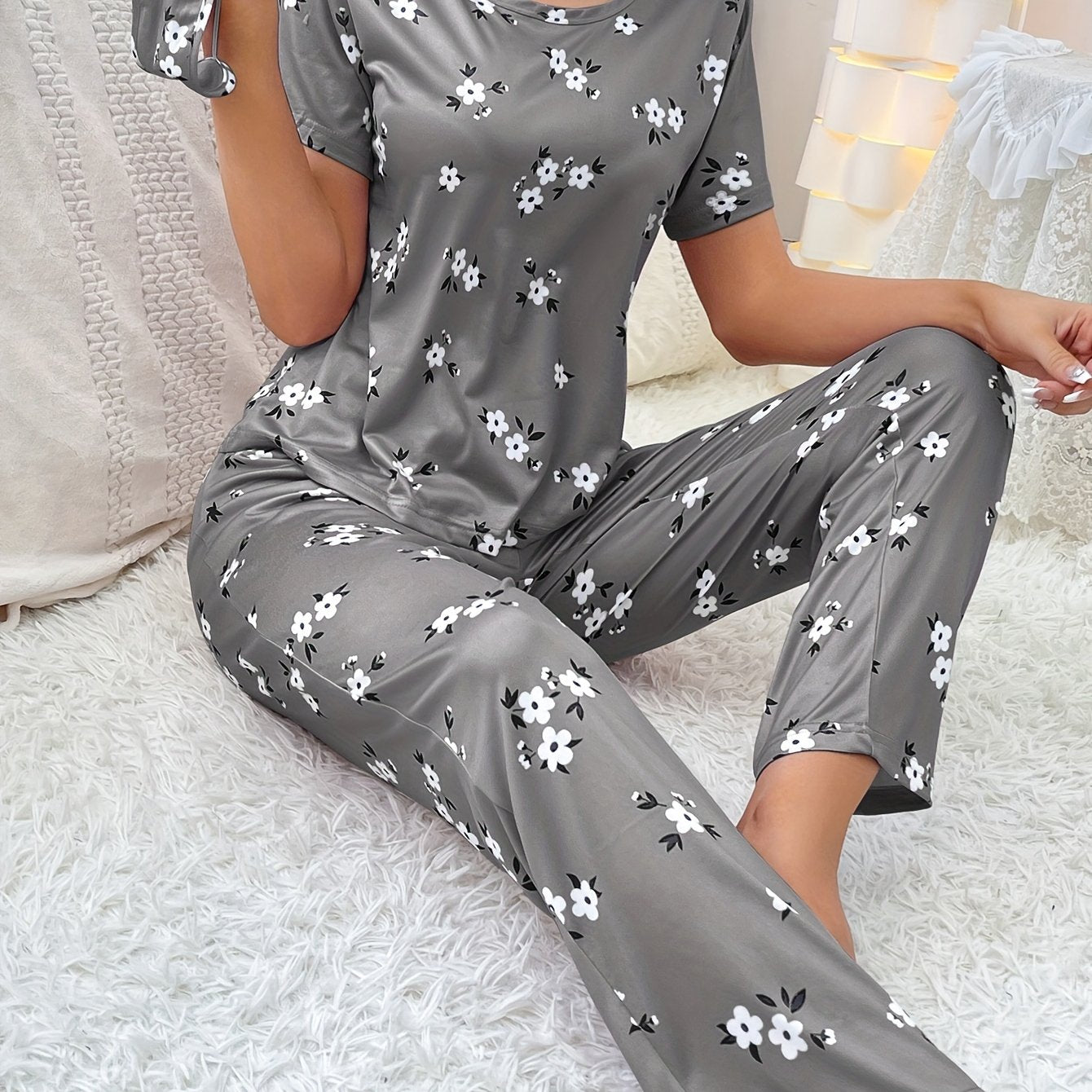 Women's floral pajama set with short sleeve top and elastic waistband pants.