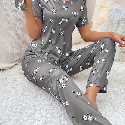 Women's floral pajama set with short sleeve top and elastic waistband pants.