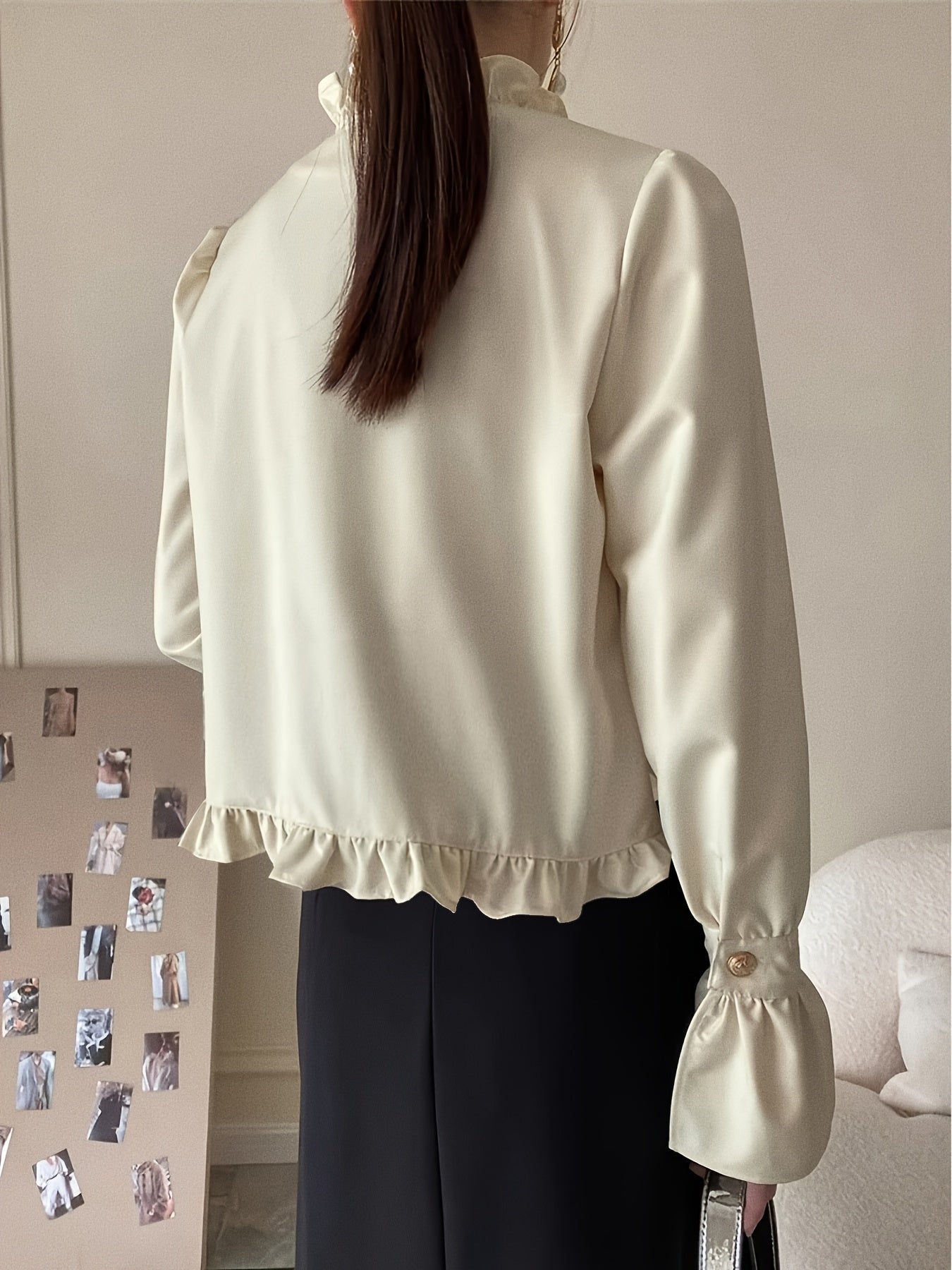 Stylish cream blouse with ruffle trim and stand collar for fashionable women.