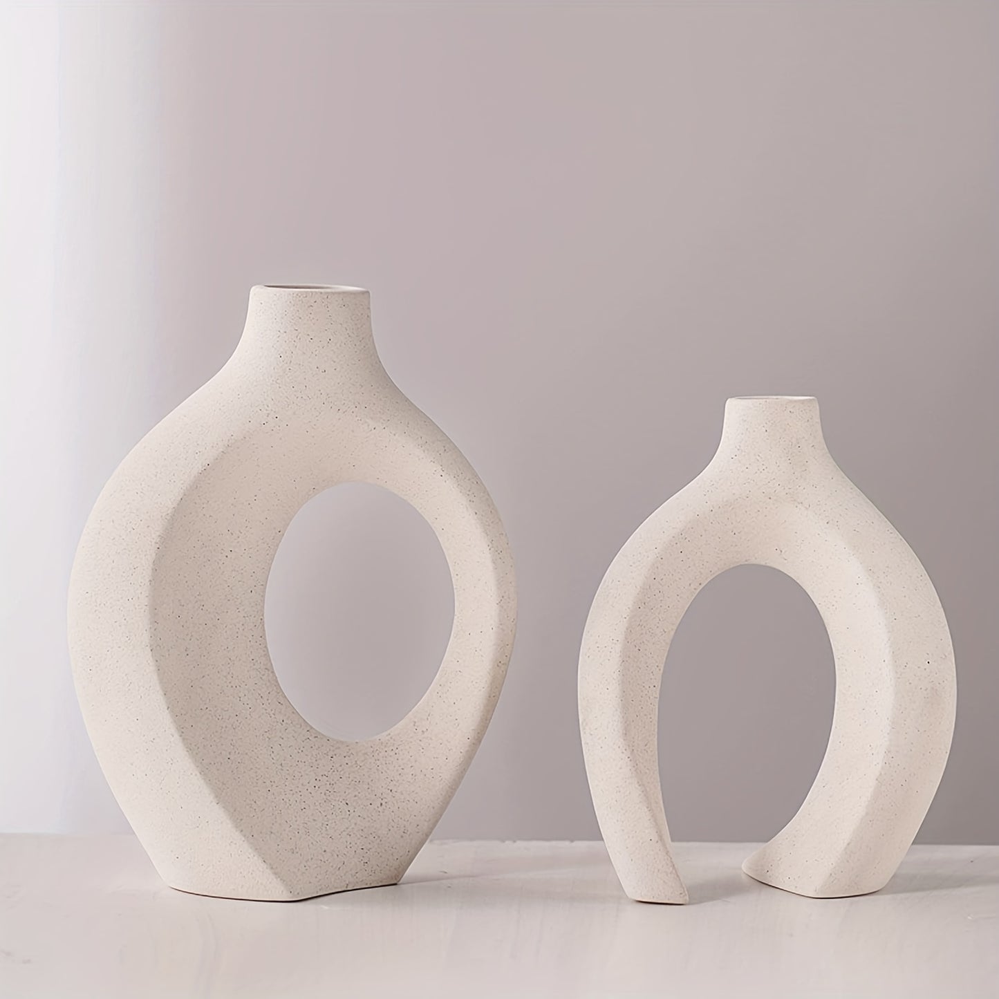 The handcrafted vase features a unique scene of couples cuddling, with two separate vases and a hollow middle that doubles as a work of art, creating a modern atmosphere no matter where it is placed.