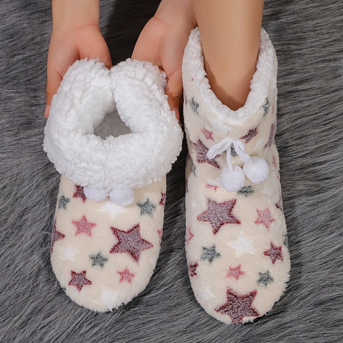 Heart-patterned slipper boots with cozy fleece lining, machine washable for indoor wear.