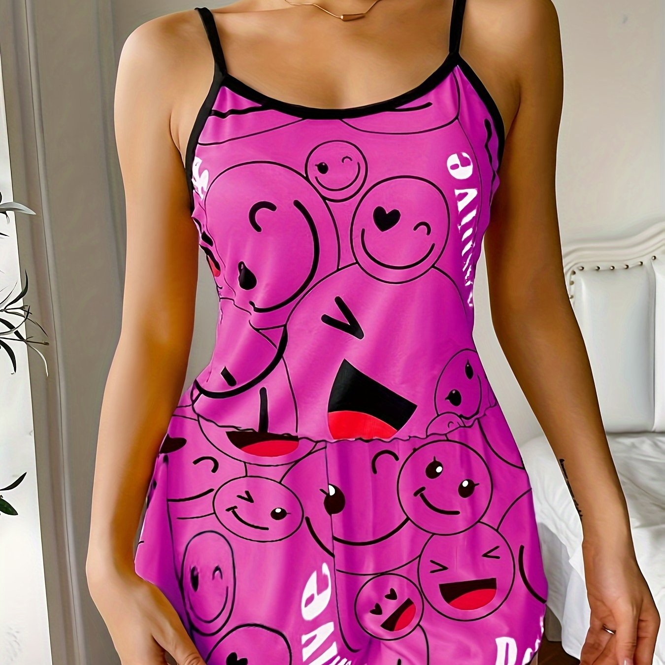 Women's sleepwear set with smiling face print cami top and elastic shorts.