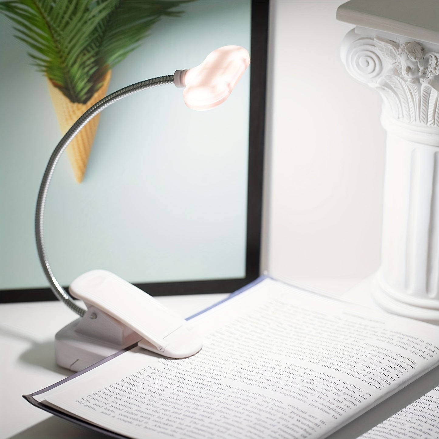 Portable battery-powered clip-on book light for reading that can also be used as a small table lamp or night light for room decor.