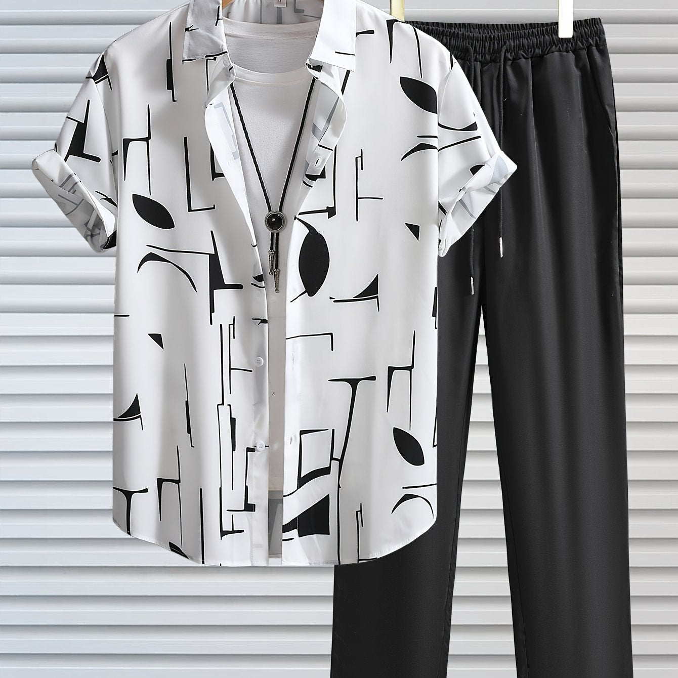 Casual geometric graphic print button-up shirt with lapels and short sleeves, paired with drawstring pants for outdoor activities.