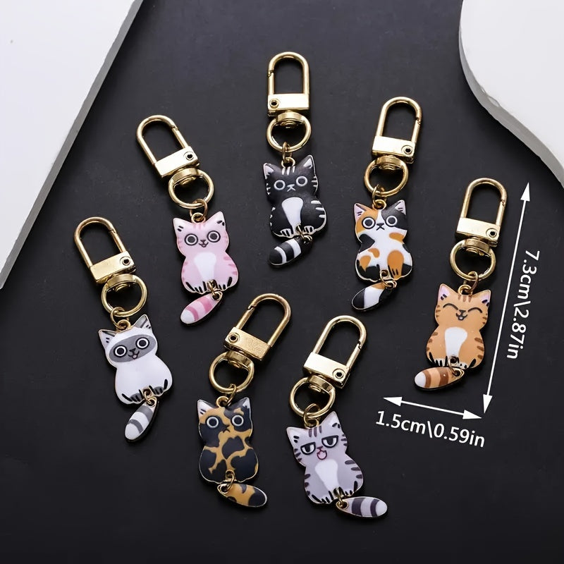 A collection of 7 adorable cat tail keychains made with zinc alloy featuring movable tails. Perfect as handbag charms and zipper pulls, these kitty keyrings make a fashionable accessory gift.