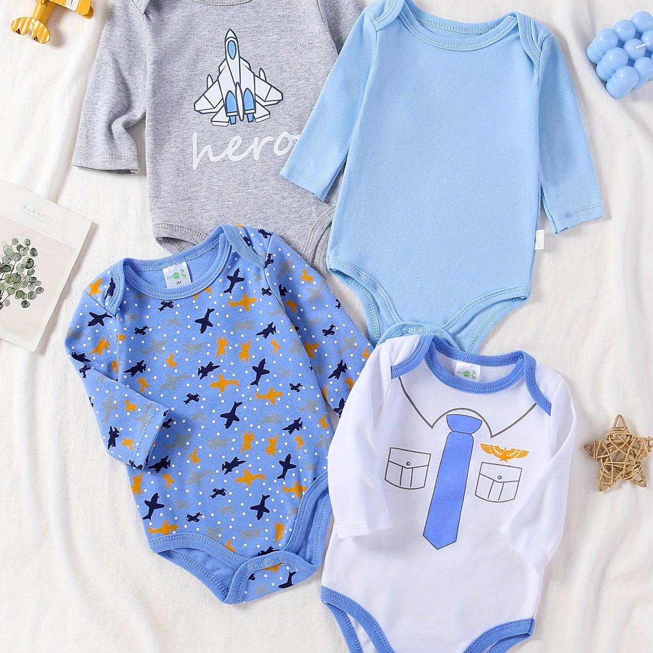 Boys' 4-pack long sleeve cotton onesies with astronaut and space patterns, perfect for fall/winter. Made with knit fabric for a regular fit and slight stretch. Suitable for outdoor wear for