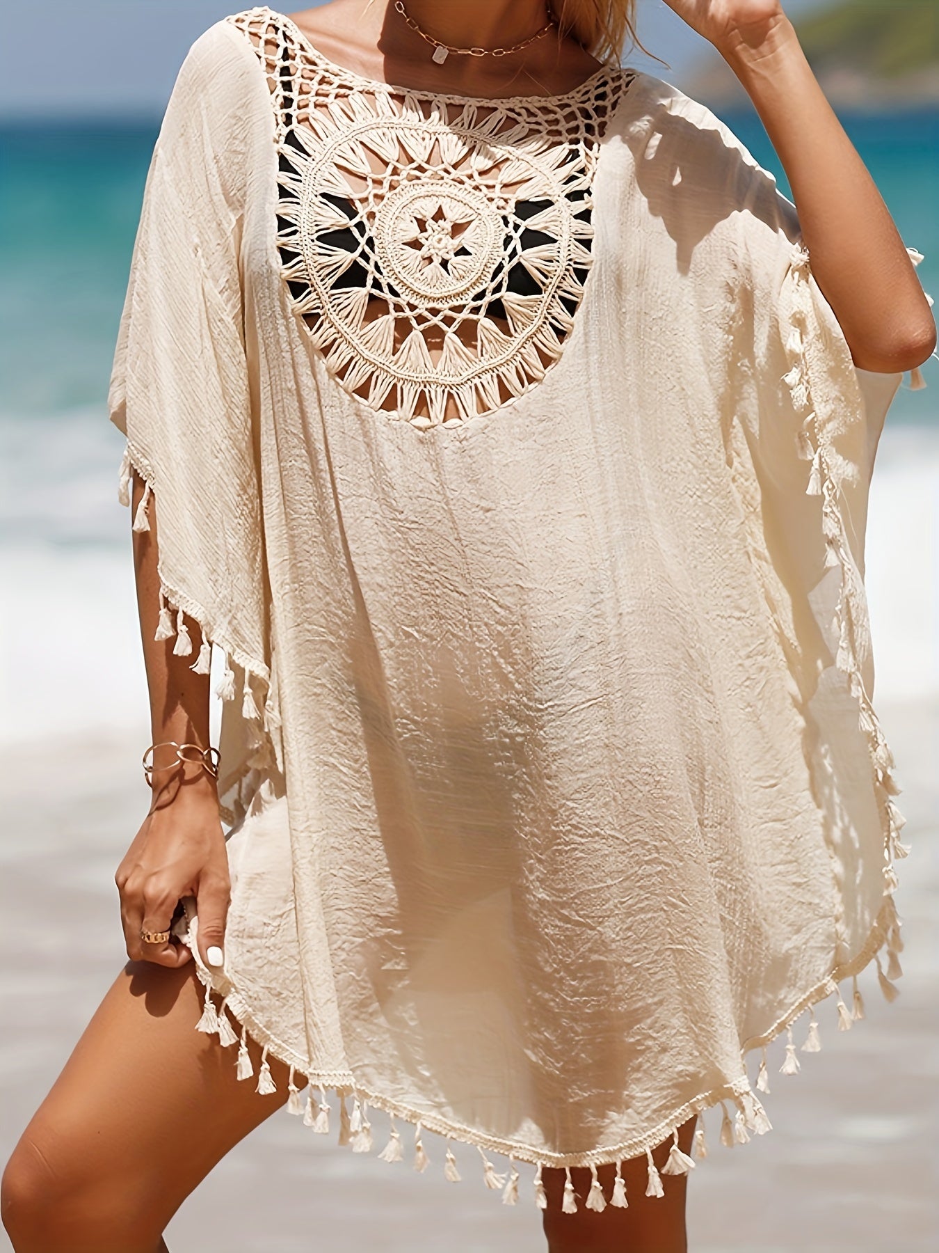 Women's casual beach vacation sunscreen shirt with solid-colored fabric spliced with small tassels for a sexy cover-up style.