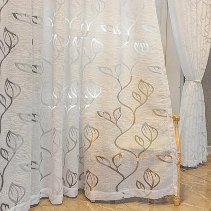 Add a touch of Nordic minimalism to your space with this elegant white sheer curtain featuring a beautiful hollow leaf design. Made with bark texture fabric, this curtain has a rod pocket top for easy hanging. Perfect for bedrooms, living rooms, and