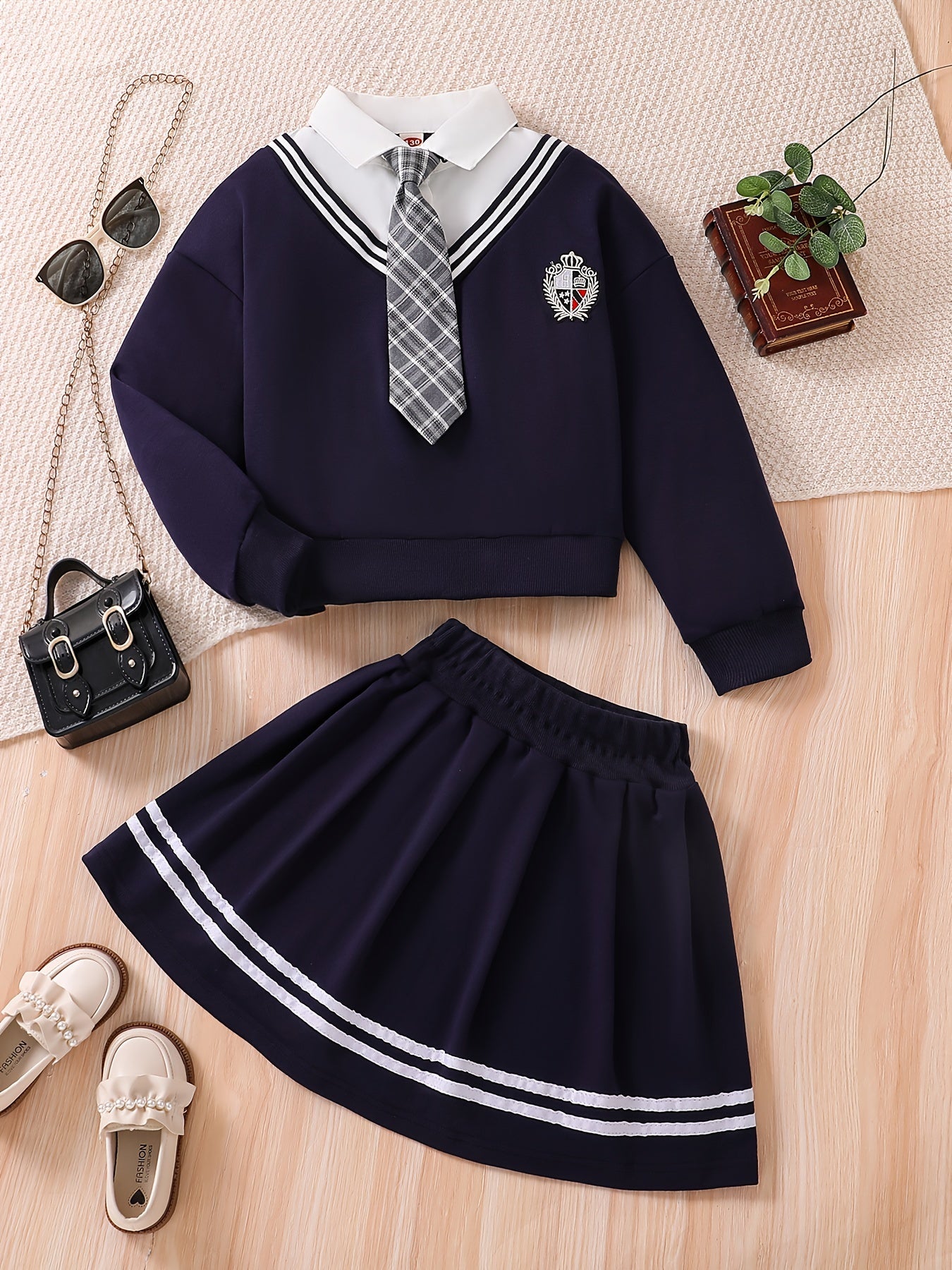 Young girl's campus style two-piece set: Short loose sweatshirt jacket + striped pleated skirt with tie.