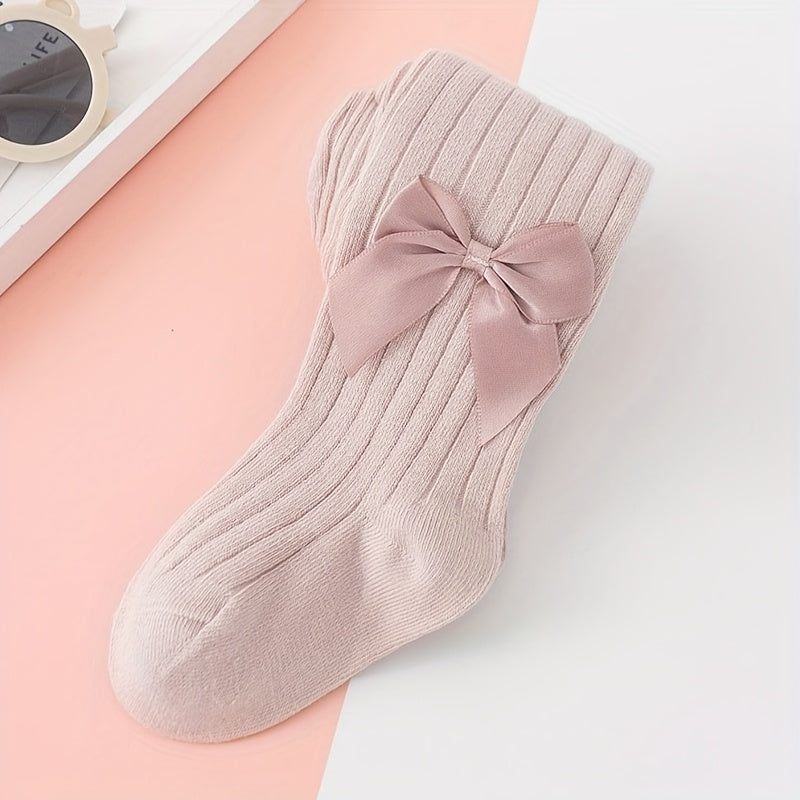 Adorable bow-knot girls' leggings socks in soft ribbed knit, perfect for dance and casual attire. Available in various colors.