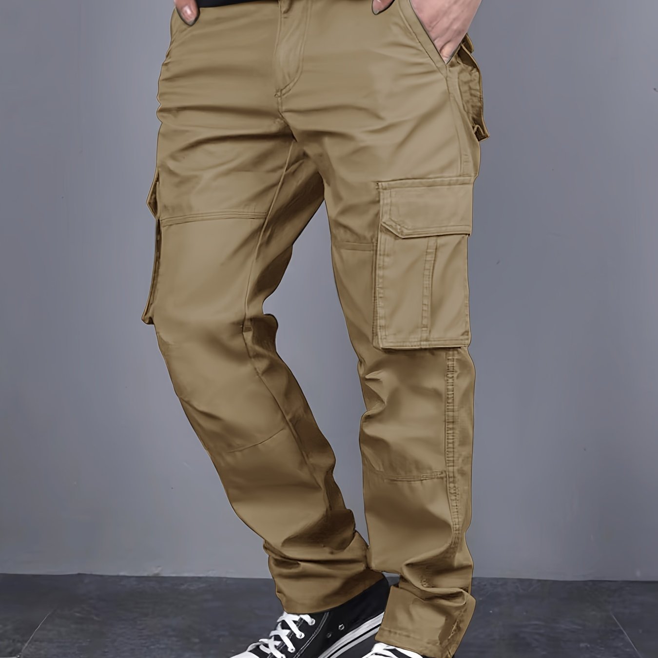 Solid color cargo pants with multiple flap pockets and a drawstring waistband, perfect for outdoor activities like hiking, fishing, and camping.