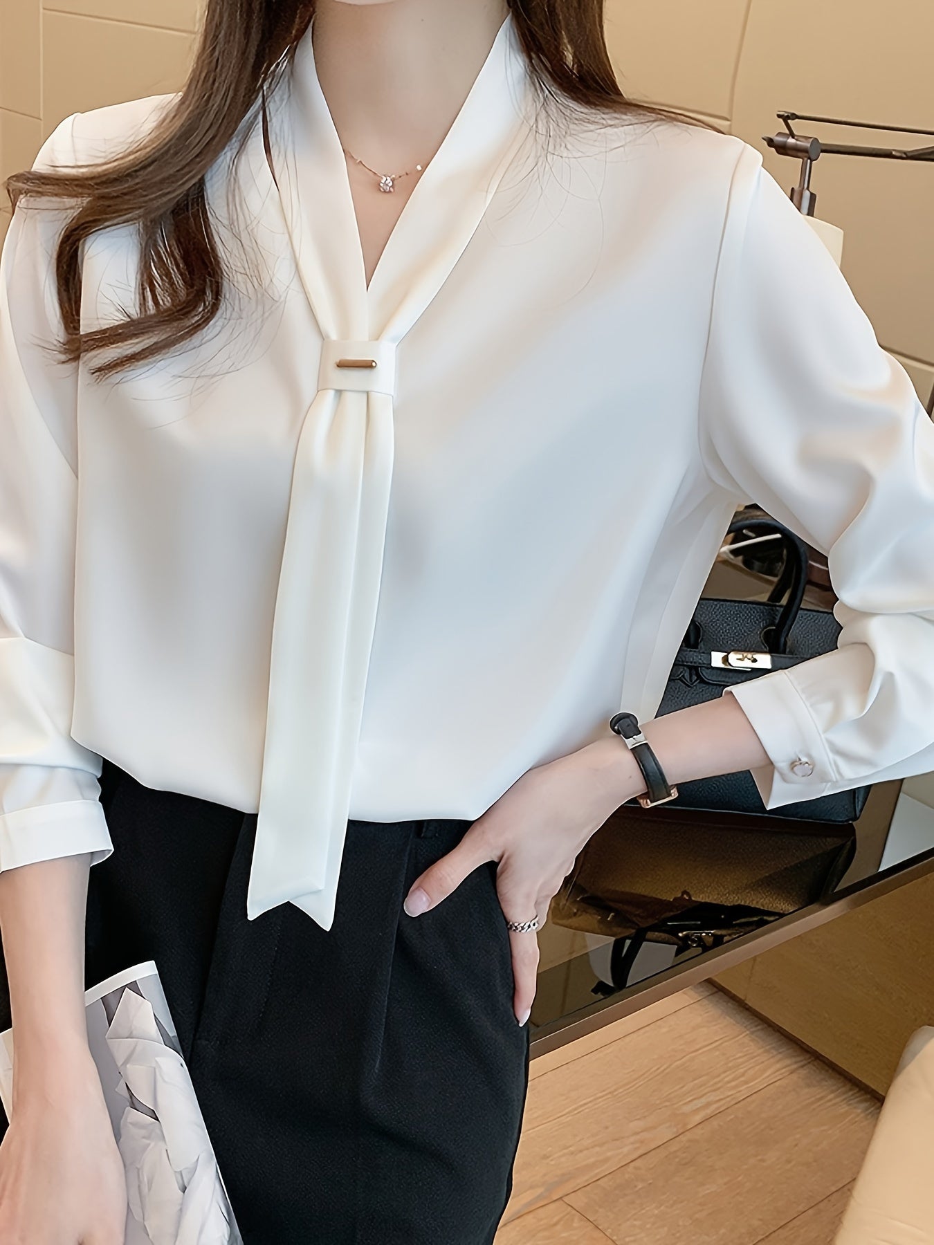 Slimming white chiffon blouse with tie-neck design, perfect for work or casual wear.