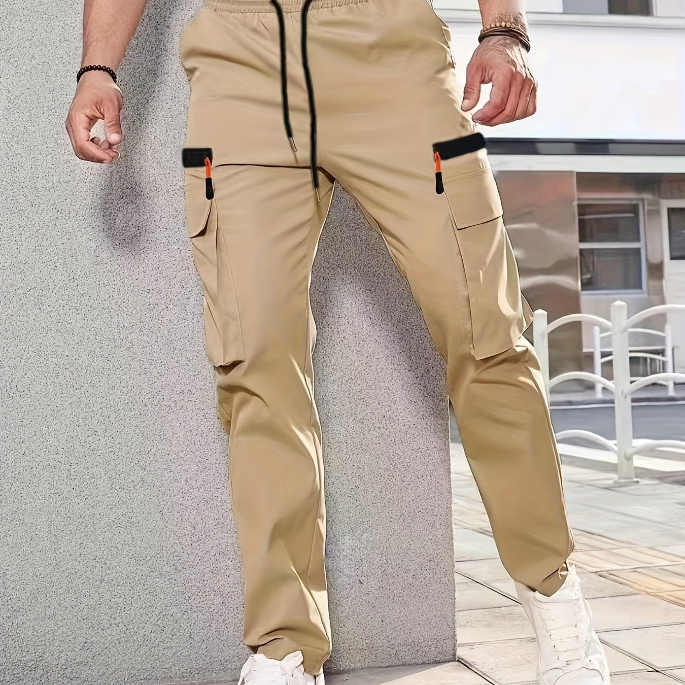 Men's casual cargo pants made of solid color polyester, feature a regular fit, multiple pockets, and straight-leg design for sports and leisure activities all year round.