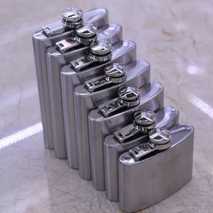 Portable stainless steel hip flask for alcohol, with screw cap and pocket-sized design for outdoor use.