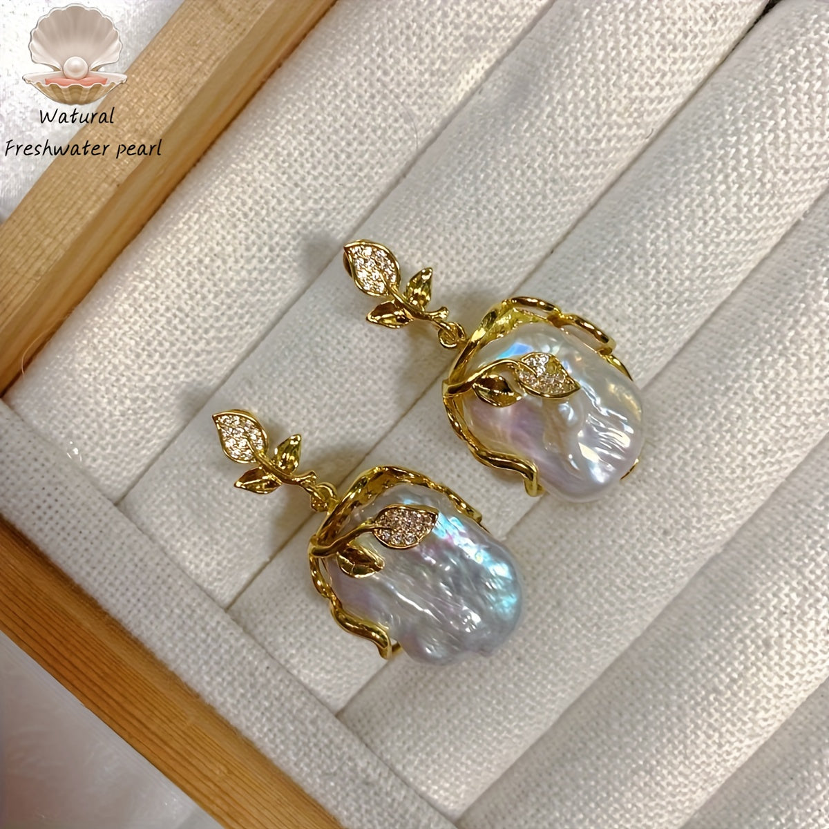 Elegant and luxurious French-inspired freshwater pearl earrings with gold-plated silver leaf accents, perfect for fashion-forward women with a taste for retro style and natural beauty.