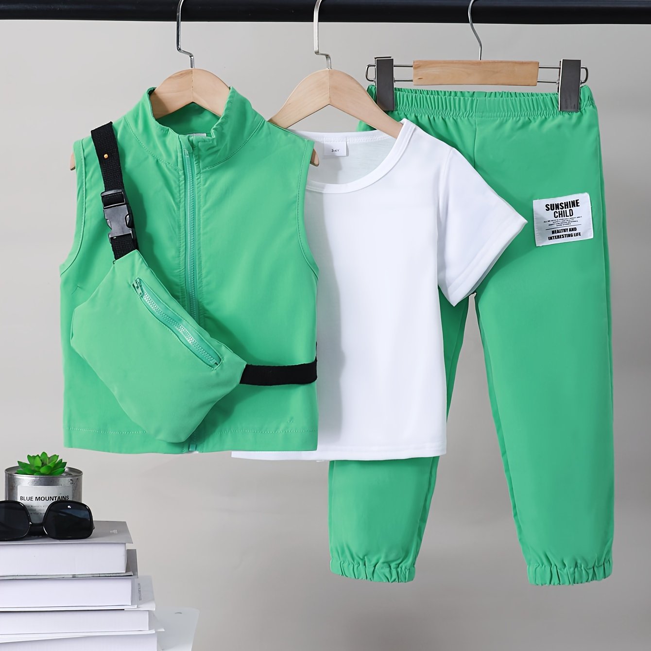 Boys 4-piece spring outfit: Short sleeve t-shirt, sleeveless vest, cargo pants, and crossbody bag. Cool, lightweight, and comfy for outdoor wear.