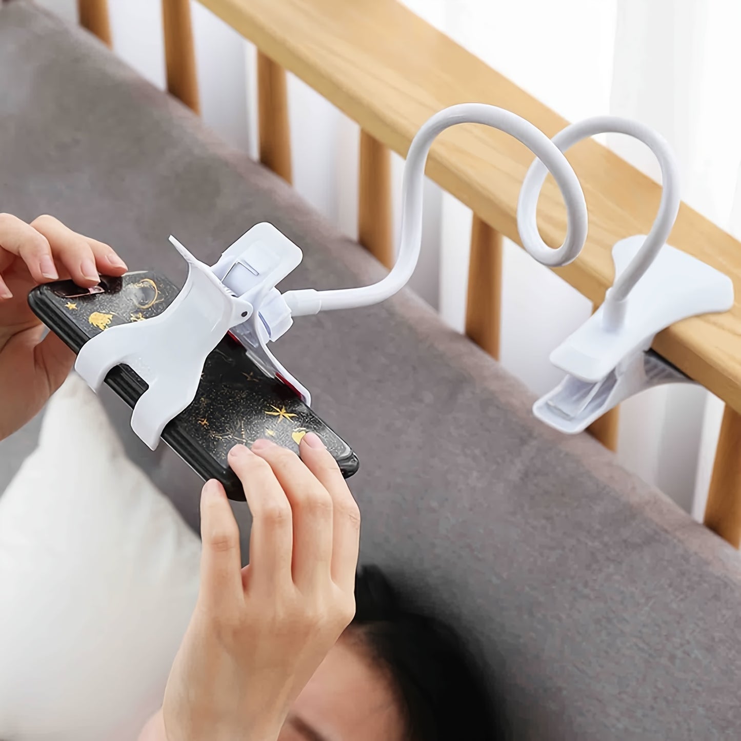 Flexible arm clamp stand for smartphones, adjustable for desktop or bedside use. Portable design allows for hands-free viewing with foldable convenience.