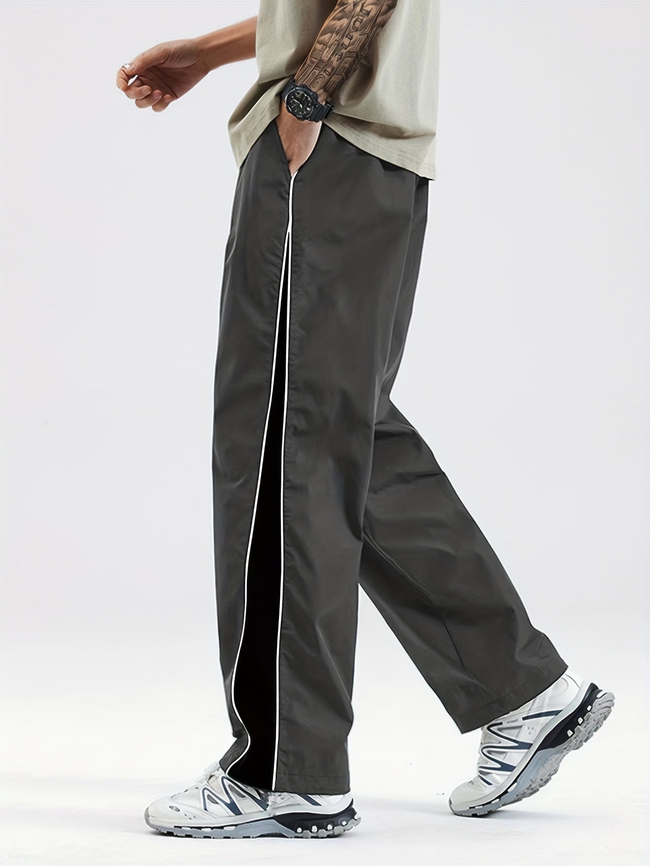 Men's black lightweight joggers with drawstring waist, perfect for spring and fall. Made of polyester fabric with a loose fit and glossy finish.