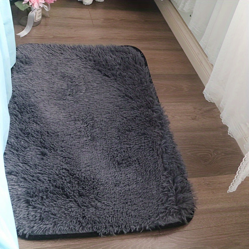 Soft and luxurious light gray plush floor mat with non-slip backing for ultimate comfort and safety. Made of ultra soft, fluffy polyester, this mat is perfect for use in the bedroom, bathroom, or living room. It is machine washable, making it easy to