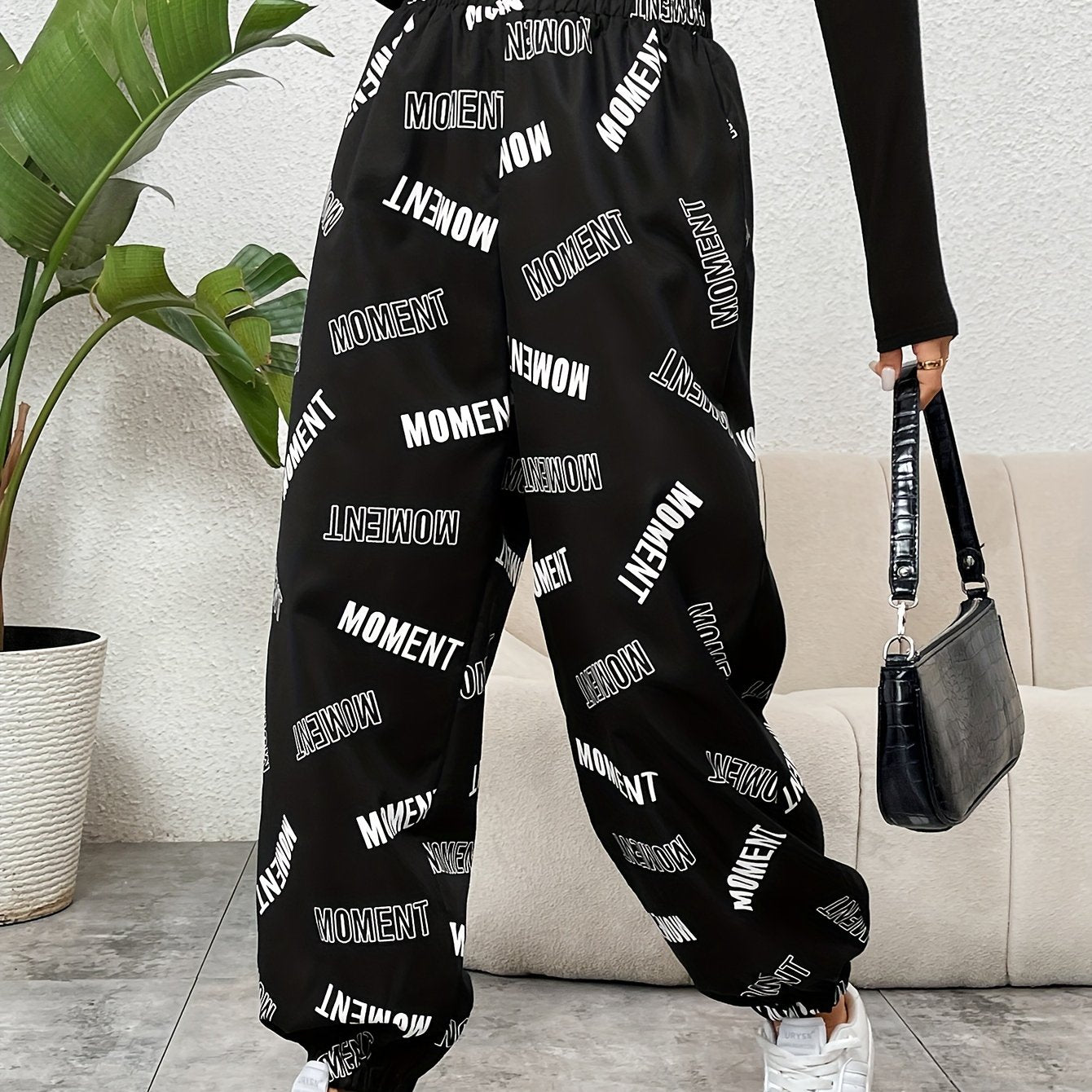 Stylish monogrammed pants for women with elastic waistband, suitable for casual or dressy occasions. Made of polyester, machine washable, and versatile in style.