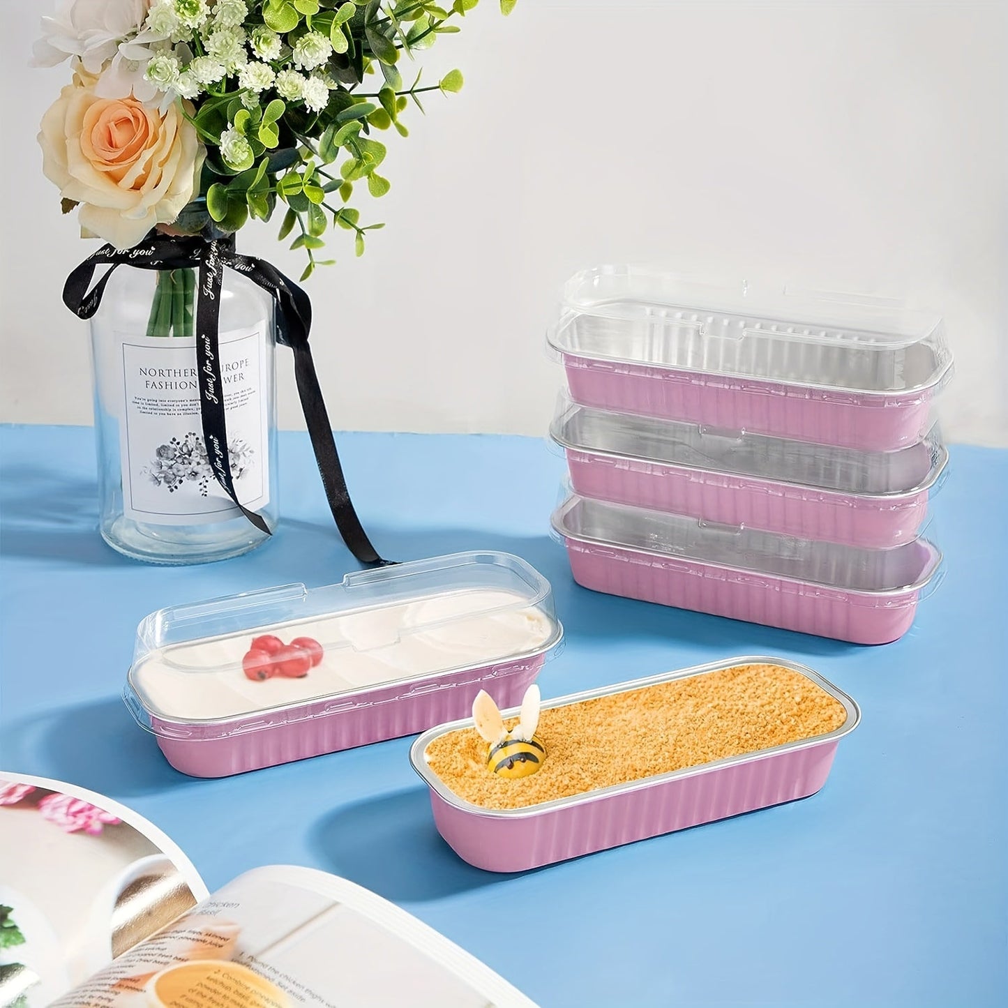 This package includes 10 mini loaf pans made of aluminum foil, each with a transparent lid. Each pan measures 16.51 cm by 6.35 cm by 3.05 cm, making them ideal for baking mini cakes and cupcakes. Available in black, pink, and golden colors.