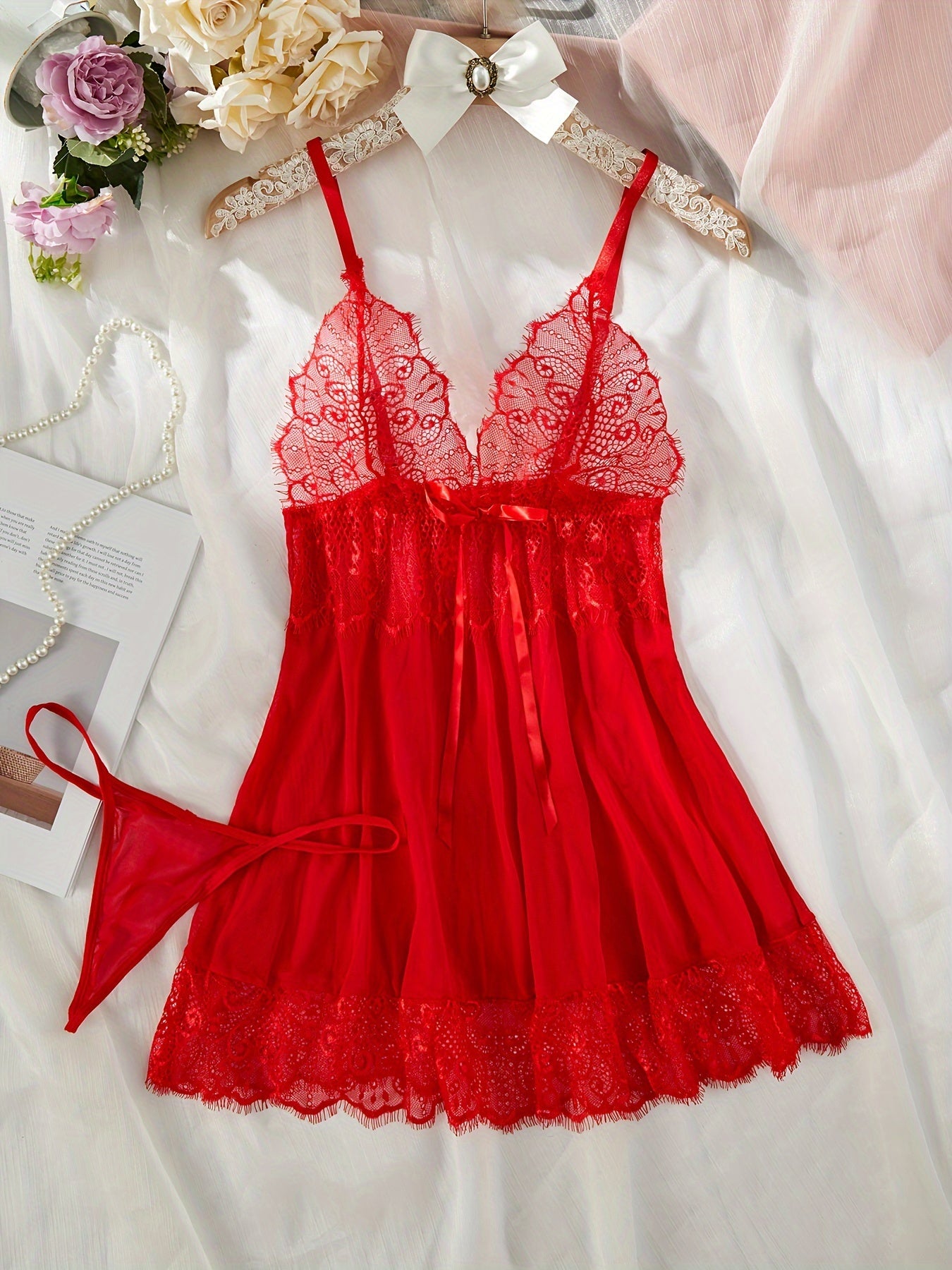 Sexy red lingerie set with lace and bow details, includes dress and thong. Perfect for women.