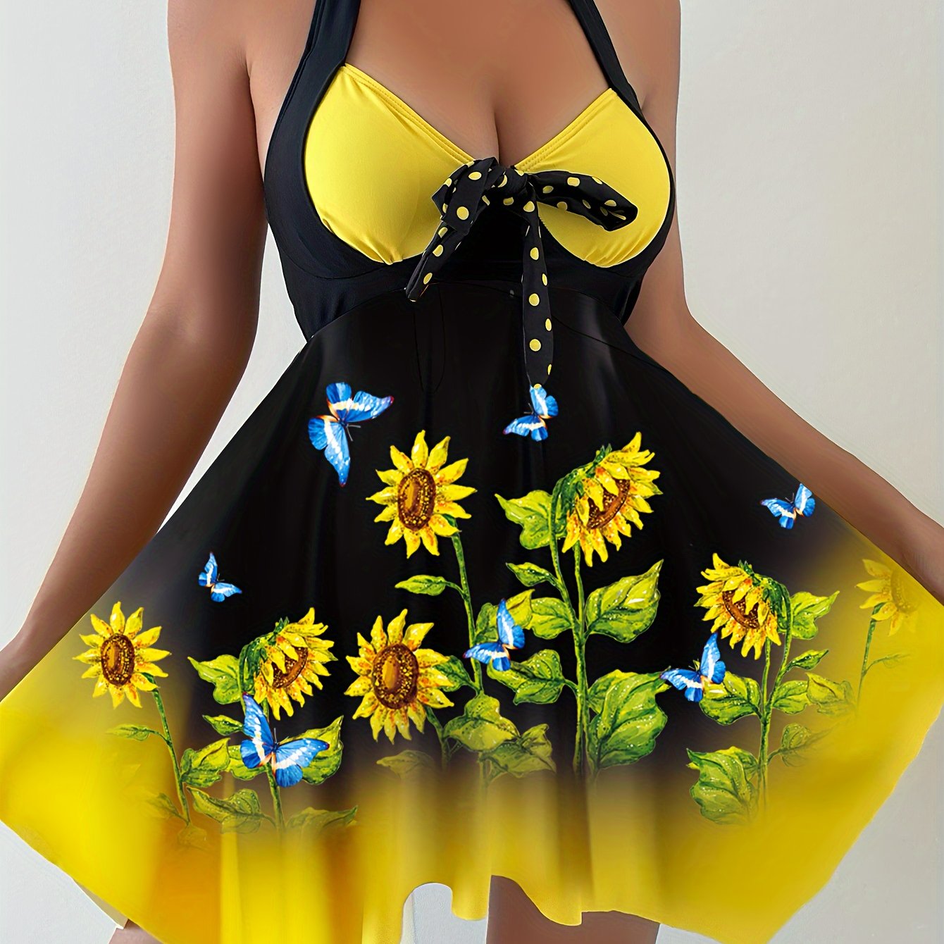 Women's 2 piece tankini set with sunflower print top, bow swim dress, and dot print bottoms.